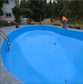 Resurfaced swimming pool with fresh blue coating