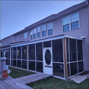 Screened porch addition built onto the back of a home