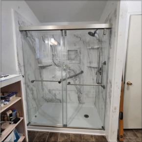New sliding glass shower enclosure with marble wall panels