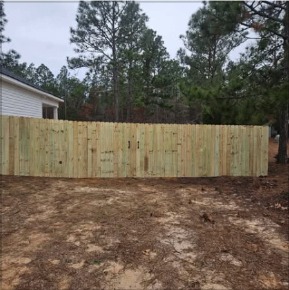 New wood privacy fence installed along a property line
