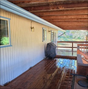 Freshly stained wood deck under a covered porch